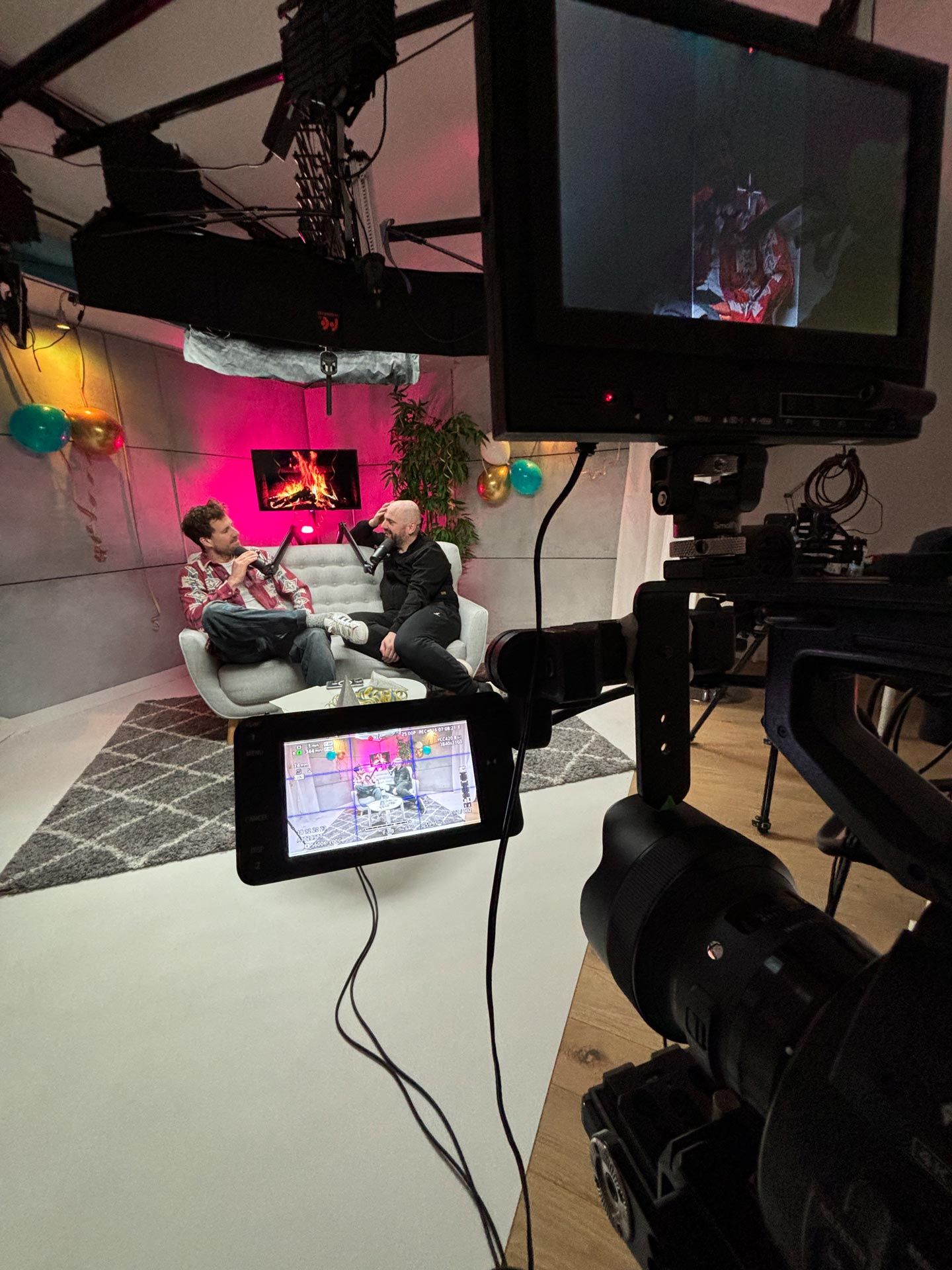 Das Bild zeigt eine Videopodcast-Aufnahme von 2Life, durchgeführt von Shotmedia. Luke Mockridge und Ingmar Stadelmann sitzen vor Mikrofonen in einem professionellen Studio und führen eine Diskussion.